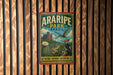 A vintage-style metal sign for Araripe Park in Brazil, featuring a bird and a cactus, is displayed on a wooden wall.