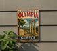 A vintage-style metal sign advertising the Archaeological Site of Olympia, Greece, featuring an illustration of the ancient ruins of Olympia.