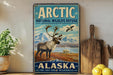 A vintage-style sign for the Arctic National Wildlife Refuge in Alaska, featuring a reindeer and mountains in the background.