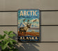 A vintage-style sign for the Arctic National Wildlife Refuge in Alaska, featuring a reindeer and a bird in a scenic landscape.