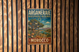 A vintage metal sign with the text "ARGANERAE BIOSPHERE RESERVE" and "MOROCCO" is displayed on a wooden wall.