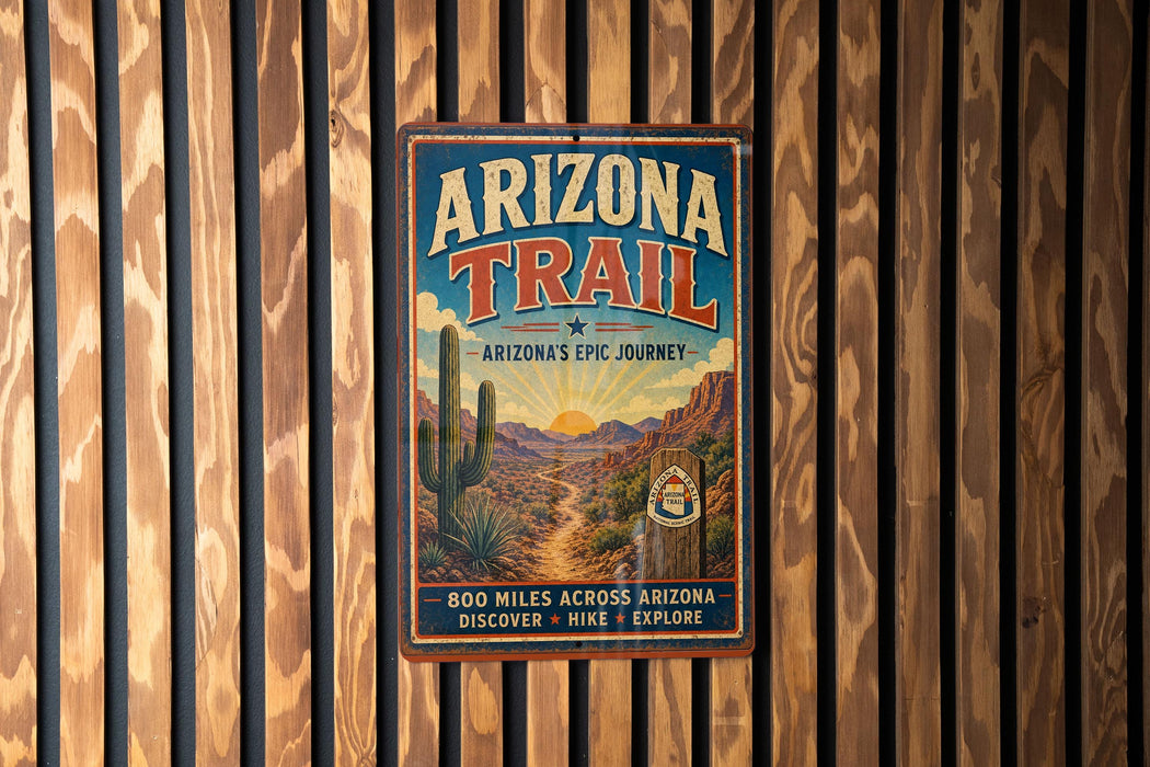 A vintage metal sign for the Arizona Trail, featuring a desert landscape with a cactus and mountains in the background.