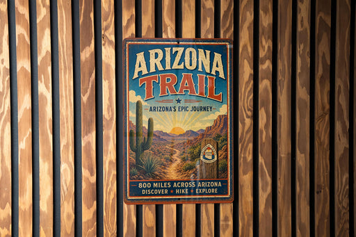 A vintage metal sign for the Arizona Trail, featuring a desert landscape with a cactus and mountains in the background.