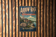 A vintage-style metal sign for Arrow Rock State Historic Site in Missouri, featuring a scenic illustration of a river and buildings.