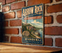 A vintage-style metal sign for Arrow Rock, a historic site in Missouri, is displayed on a brick wall.
