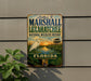 A vintage metal sign for the Marshall and Loxahatchee National Wildlife Refuge in Florida, featuring a white egret and a sunset landscape.