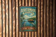 A vintage-style metal sign for Ashtamudi Wetland in India, featuring a tropical landscape with palm trees, birds, and a boat on the water.