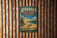 A vintage metal sign for Athabasca Sand Dunes Provincial Park in Saskatchewan, Canada, hanging on a wooden wall.