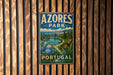 A vintage-style metal sign with the text "AZORES PARK PORTUGAL" is displayed on a wooden wall.