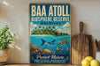 A vintage-style poster with a tropical island scene, featuring a sea turtle, coral, and fish, is displayed on a wall next to a wooden cutting board and a potted plant.
