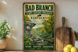 A vintage-style poster advertising Bad Branch State Nature Preserve in Kentucky, featuring a scenic image of a forest and a river.