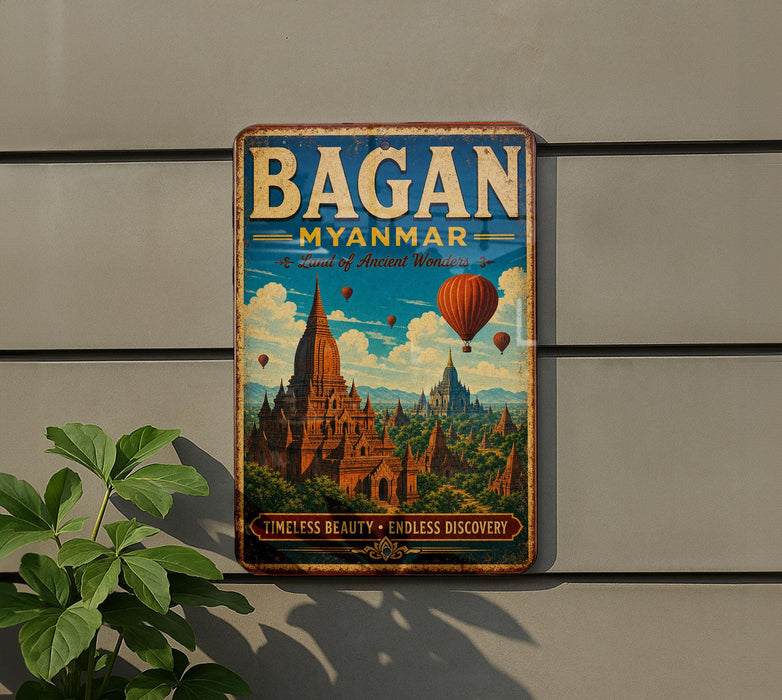 A vintage-style metal sign with the text "BAGAN MYANMAR" and an illustration of a temple surrounded by hot air balloons, hanging on a wall.
