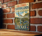 A vintage-style metal sign for the Balcones Canyonlands National Wildlife Refuge in Texas, featuring an illustration of the landscape and wildlife.