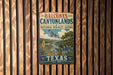 A vintage metal sign for Balcones Canyonlands National Wildlife Refuge in Texas, featuring an illustration of a scenic landscape with a bird in flight.