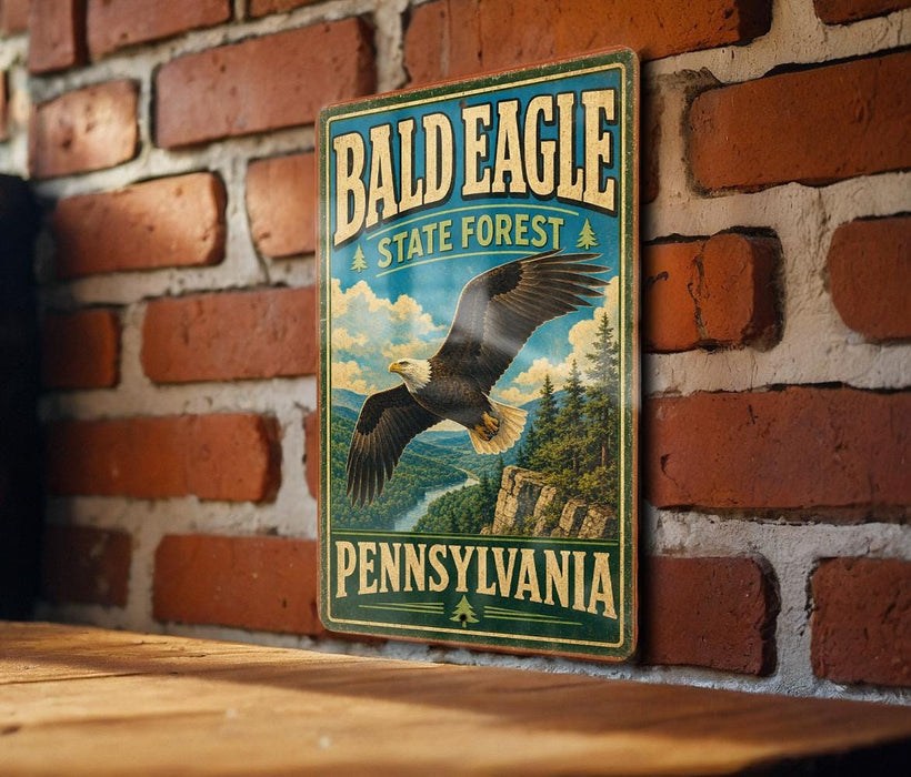A vintage metal sign for the Bald Eagle State Forest in Pennsylvania, featuring an eagle in flight against a scenic landscape.
