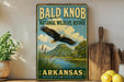 A vintage-style metal sign for the Bald Knob National Wildlife Refuge in Arkansas, featuring an eagle in flight over a scenic landscape.
