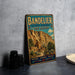 A vintage-style metal sign for the Bandelier National Monument in New Mexico, featuring an illustration of the historic site with a desert landscape and a prominent building.