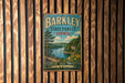 A vintage metal sign for the Barley State Forest in Iowa, featuring a scenic landscape with a river and trees.