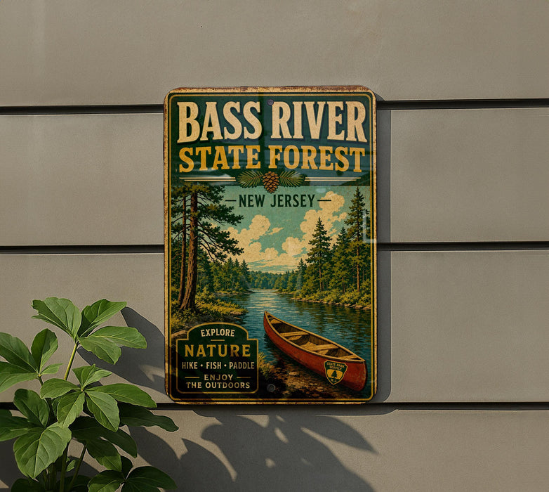 A vintage-style metal sign for Bass River State Forest in New Jersey, featuring a canoe and a scenic landscape.