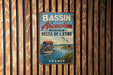 A vintage metal sign with the text "BASSIN d' Arcachon" and "SECTIEUR DU L'EYRE DELTA DE L'EYRE" is displayed on a wooden wall.