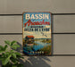 A vintage metal sign advertising the Bassin de Arcachon, a coastal town in France, with a scenic illustration of a boat on the water and a house on the shore.