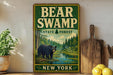 A vintage-style sign for Bear Swamp State Forest in New York, featuring a black bear in a forest setting.