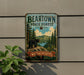 A vintage metal sign for the Bearstown State Forest in Massachusetts, featuring a bear and a scenic landscape.