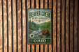 A vintage metal sign for Beaver Creek State Forest in Ohio, featuring a beaver in a forest setting.