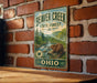 A vintage metal sign for Beaver Creek State Forest in Ohio, featuring a beaver in a forest setting.