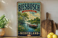 A vintage-style sign for Biesbosch National Park in the Netherlands, featuring a scenic image of a boat on a river surrounded by lush greenery.