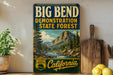 a vintage-style sign for the Big Bend State Forest, with a scenic mountain landscape and a river depicted on it. The sign is displayed on a shelf, surrounded by various kitchen utensils and a potted plant.