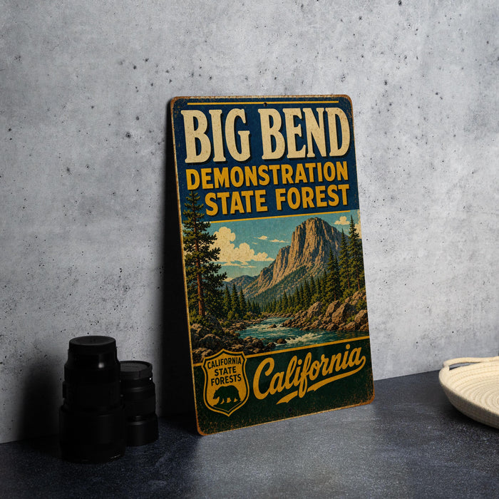A vintage metal sign for the Big Bend State Forest in California, featuring a scenic mountain landscape.