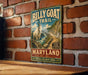 A vintage-style metal sign for the Billy Goat Trail in Maryland, featuring a mountain landscape with a goat on a cliff.