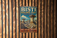 A vintage metal sign for the Bisti Badlands Trail in New Mexico, featuring a scenic illustration of the trail and rock formations.