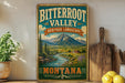 A vintage-style sign for Bitterroot Valley, Montana, featuring a scenic landscape with mountains, a river, and a wooden sign.