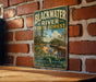 A vintage-style sign for the Blackwater River State Forest in Florida, featuring a scenic image of the river surrounded by lush greenery.