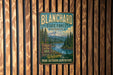 A vintage metal sign for Blanchard State Forest in Washington, featuring a scenic mountain landscape and inviting visitors to "Welcome to your outdoor adventure".