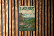 A vintage-style sign for Blanton Forest State Nature Preserve in Kentucky, featuring a scenic illustration of a forest, a deer, and a waterfall.