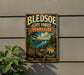 A vintage-style metal sign for the Blendedoe State Forest in Tennessee, featuring a scenic landscape with a river, mountains, and pine trees.