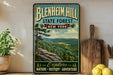 A vintage-style metal sign for Blenheim Hill State Forest in New York, featuring a scenic landscape with pine trees and mountains.