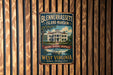 A vintage-style metal sign for Blennerhaslett Island mansion in West Virginia, featuring an illustration of the mansion and a river.