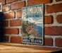A vintage-style metal sign for Blomidon Provincial Park in Nova Scotia, featuring a scenic coastal landscape with cliffs and a body of water.