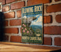 A vintage-style metal sign for the Blowing Rock State Natural Area in North Carolina, featuring a scenic illustration of the rock formation and surrounding landscape.