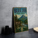 A vintage-style metal sign for the Blue Job State Forest in New Hampshire, featuring a scenic mountain landscape and a sign welcoming visitors to the forest.