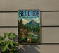 A vintage-style metal sign for the Blue Job State Forest in New Hampshire, featuring a scenic mountain landscape and pine trees.