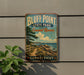 A vintage-style sign for Bluff Point State Park and Coastal Reserve in Connecticut, featuring a scenic coastal landscape with a path leading to the beach.
