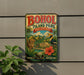 A vintage-style metal sign for BOHOL ISLAND PARK, Philippines, featuring a tropical landscape with a bird, palm trees, and a red flower.