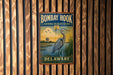 A vintage metal sign for the Bombay Hook National Wildlife Refuge in Delaware, featuring a blue heron and a serene landscape.