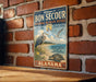A vintage-style metal sign for the Bon Secour National Wildlife Refuge in Alabama, featuring illustrations of birds and wildlife.