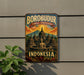 A vintage-style metal sign with the text "BOROBUDUR TEMPLE COMPOUNDS INDONESIA" and an illustration of a temple surrounded by mountains and a Buddha statue.